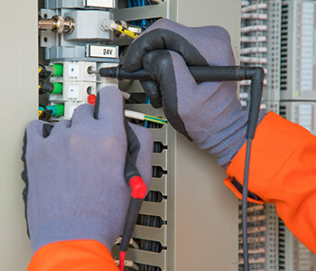 Electrical technician providing electrical maintenance services.