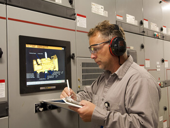 Technician assessing electrical equipment